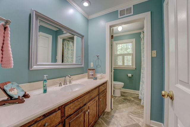 bathroom with ornamental molding, toilet, and vanity