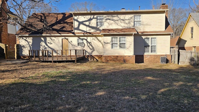 rear view of property with a lawn, central air condition unit, and a deck