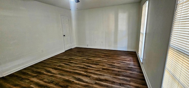 spare room with dark wood-type flooring and ceiling fan