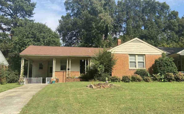 view of front of property with a carport and a front lawn