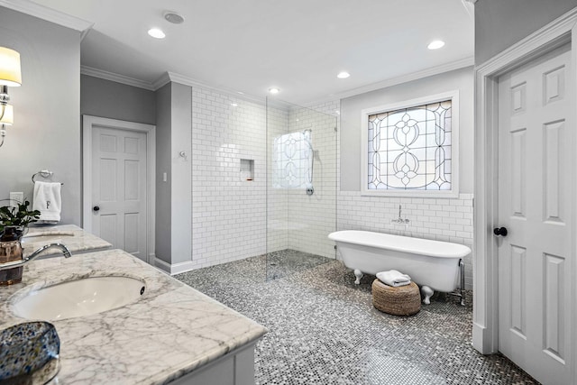 bathroom featuring tile walls, vanity, crown molding, and separate shower and tub