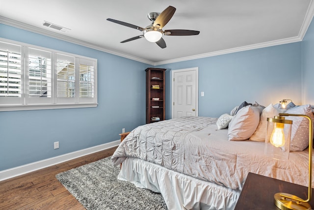 bedroom featuring ornamental molding, dark wood-type flooring, and ceiling fan