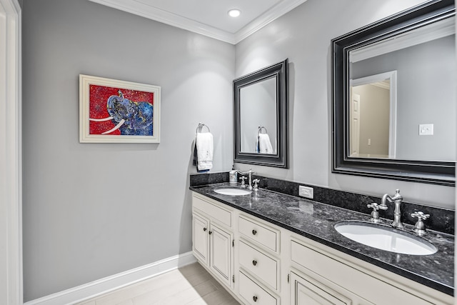 bathroom with ornamental molding and vanity