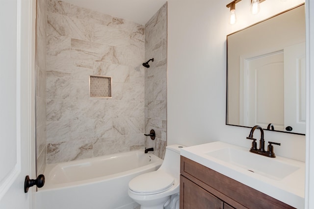 full bathroom featuring tiled shower / bath, vanity, and toilet