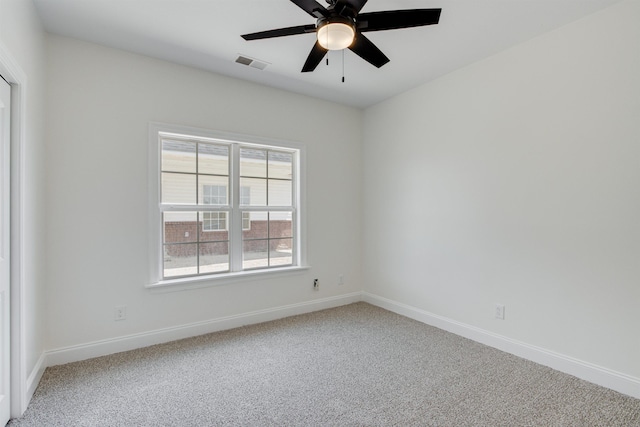 carpeted spare room featuring ceiling fan