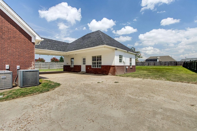 exterior space featuring central AC and a lawn