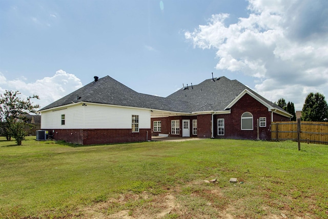 back of house featuring cooling unit and a yard