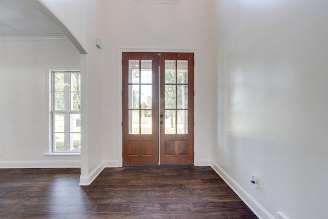 entrance foyer with crown molding, dark hardwood / wood-style floors, and french doors