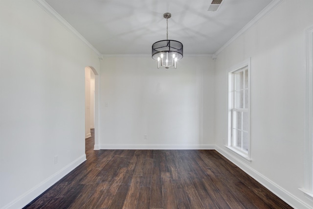 empty room featuring crown molding, dark wood-type flooring, and a chandelier