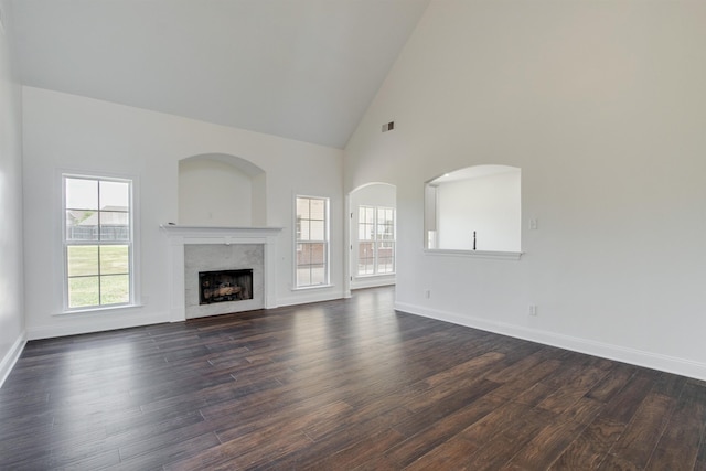 unfurnished living room featuring dark hardwood / wood-style flooring and high vaulted ceiling