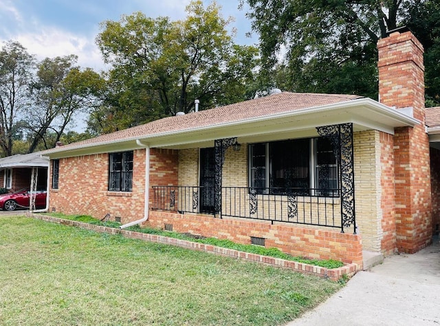 single story home with a porch and a front lawn