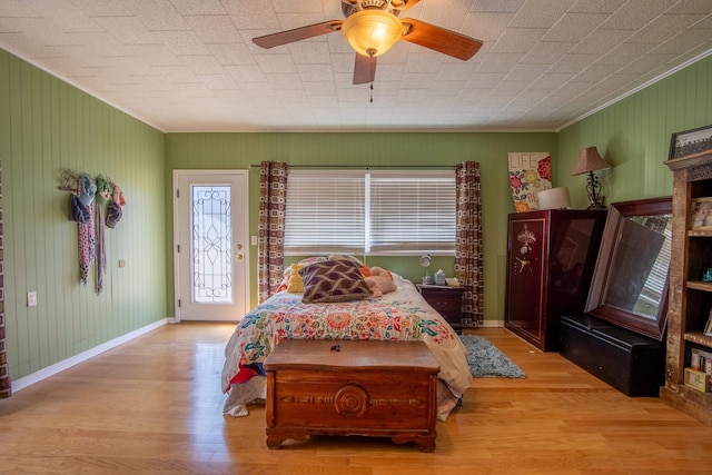 bedroom with access to outside, ornamental molding, ceiling fan, and light wood-type flooring