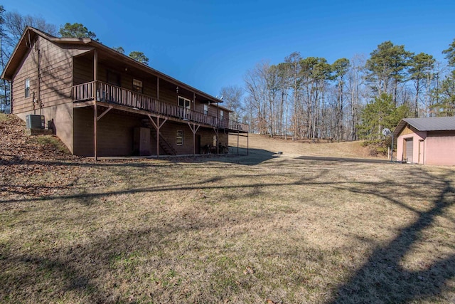 exterior space with a storage shed, a lawn, and a deck