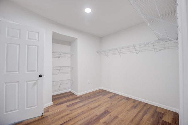 walk in closet with hardwood / wood-style floors