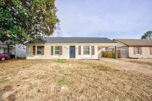 ranch-style home with a front lawn and a carport