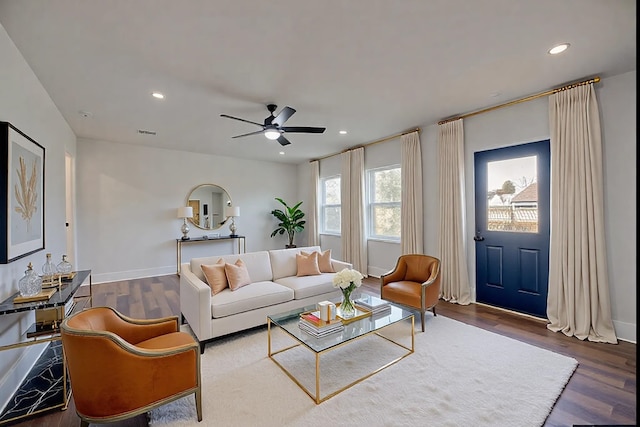 living room with dark wood-type flooring and ceiling fan