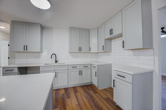 kitchen with tasteful backsplash, sink, and dark hardwood / wood-style floors