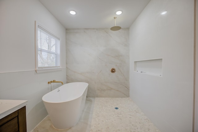 bathroom featuring vanity, shower with separate bathtub, and tile walls