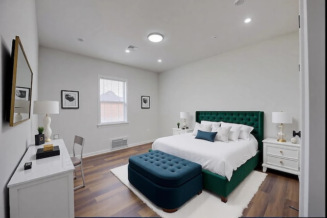 bedroom with dark hardwood / wood-style flooring