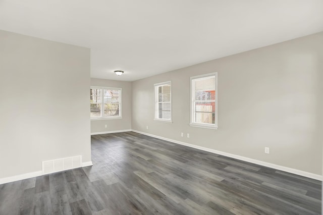 spare room with dark wood-type flooring