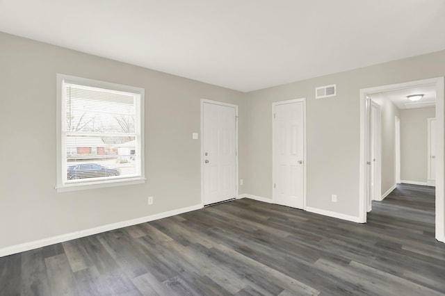 spare room with dark hardwood / wood-style flooring