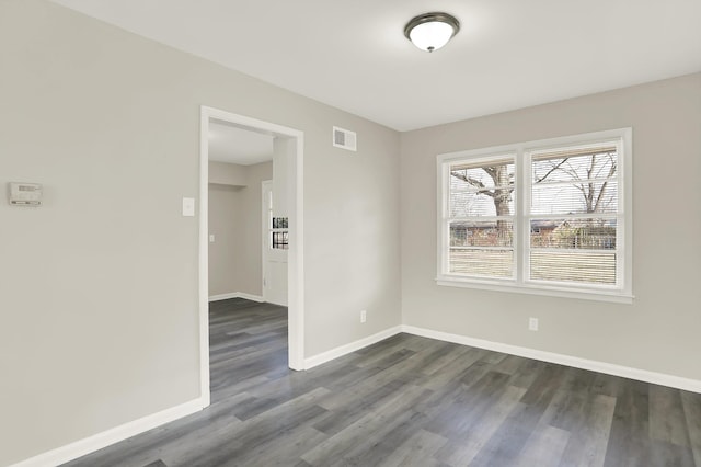 spare room with dark hardwood / wood-style flooring