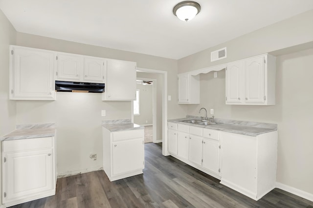 kitchen with sink, dark wood-type flooring, white cabinets, and ceiling fan