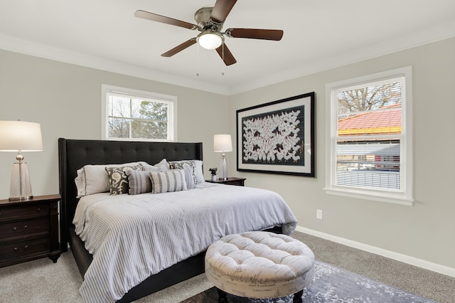 carpeted bedroom with ornamental molding and ceiling fan