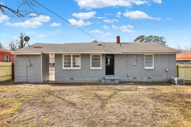 back of property with cooling unit and a yard