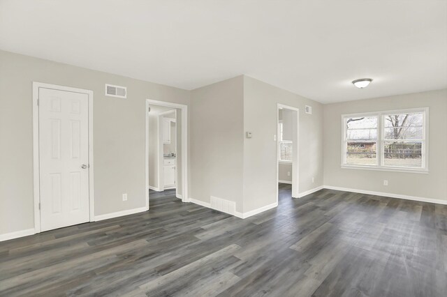 spare room featuring dark hardwood / wood-style flooring