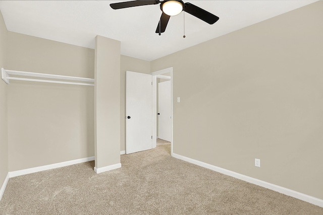 unfurnished bedroom with light colored carpet, a closet, and ceiling fan