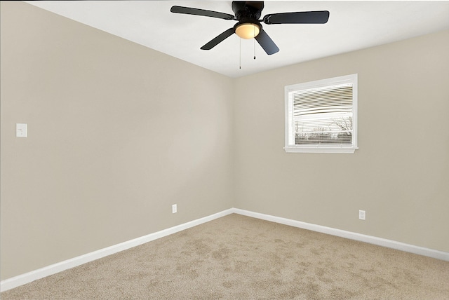 unfurnished room with ceiling fan and carpet