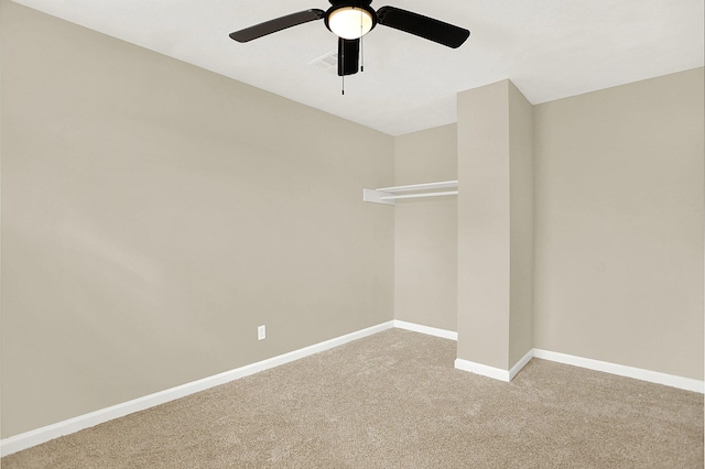 unfurnished room featuring ceiling fan and carpet flooring