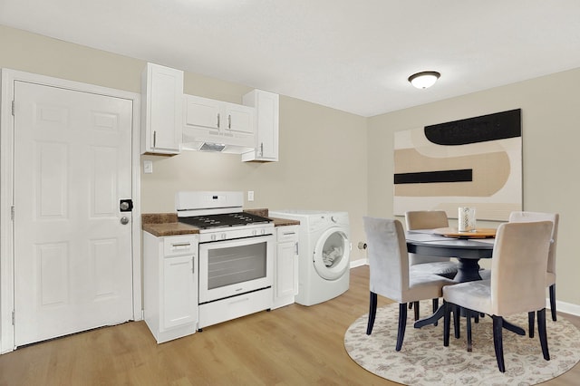 kitchen with washer / dryer, light hardwood / wood-style flooring, white gas range oven, and white cabinets