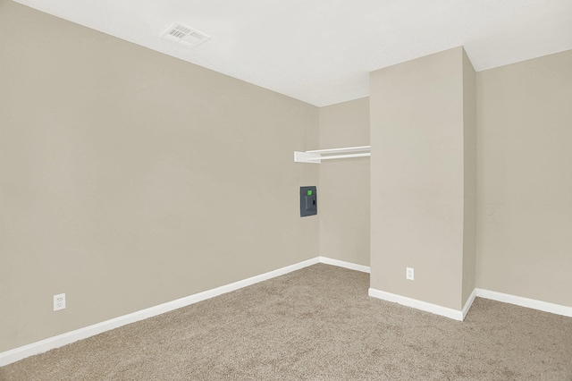 carpeted empty room featuring electric panel