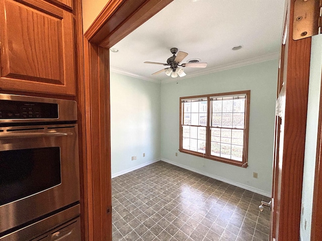 kitchen with ceiling fan, crown molding, and stainless steel double oven