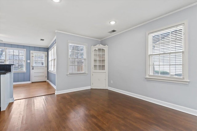 foyer with crown molding and dark hardwood / wood-style floors