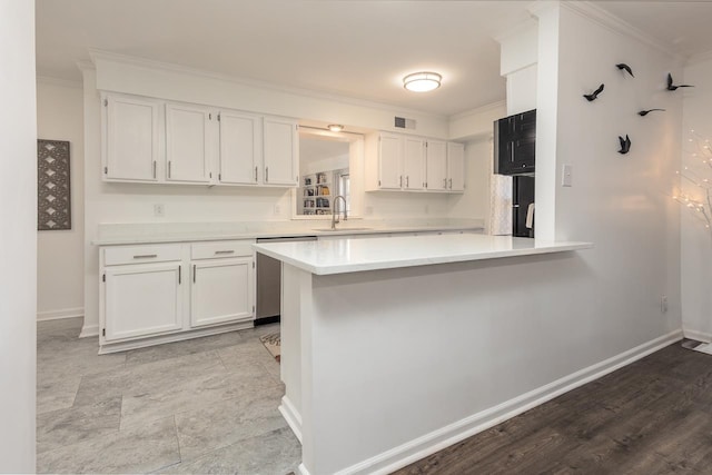 kitchen with sink, white cabinetry, stainless steel dishwasher, ornamental molding, and kitchen peninsula