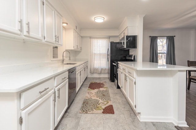 kitchen with appliances with stainless steel finishes, sink, a breakfast bar area, white cabinets, and crown molding