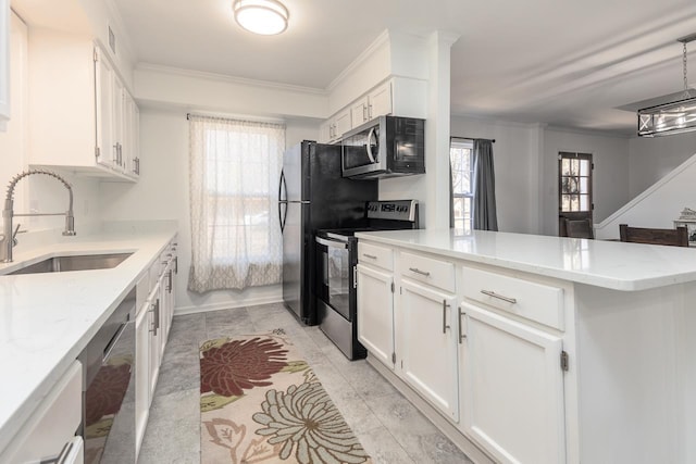 kitchen featuring sink, crown molding, appliances with stainless steel finishes, white cabinetry, and hanging light fixtures