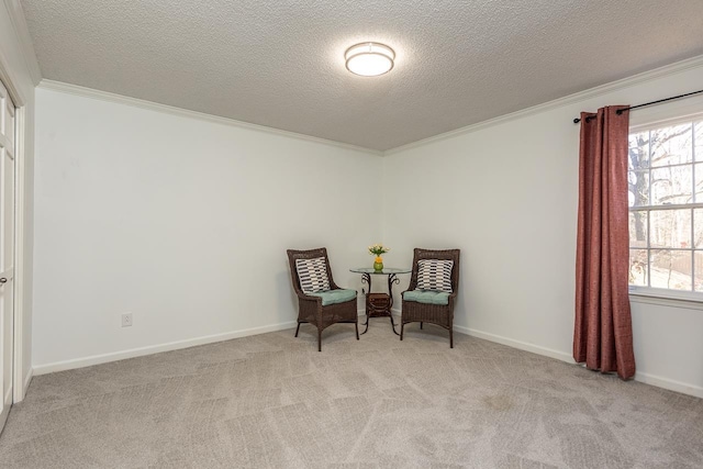 living area featuring light colored carpet, ornamental molding, and a textured ceiling