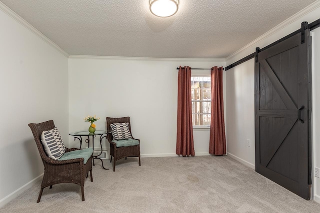 sitting room with light colored carpet, ornamental molding, a barn door, and a textured ceiling