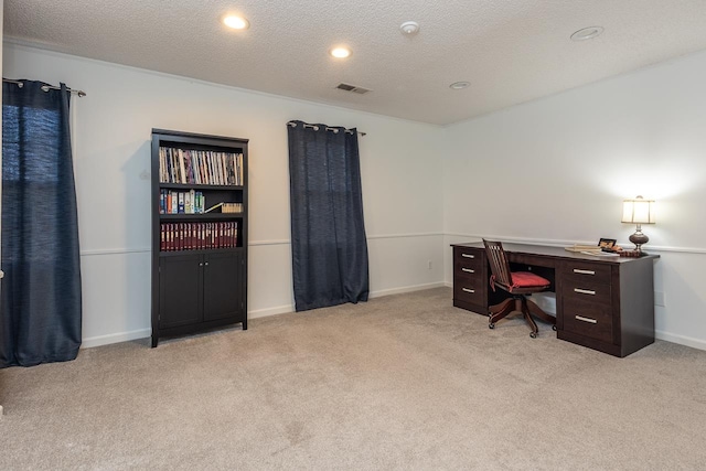 office featuring light colored carpet and a textured ceiling