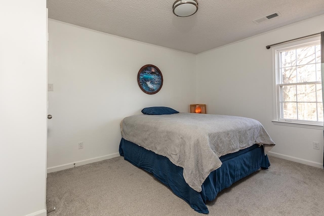 bedroom with carpet floors and a textured ceiling