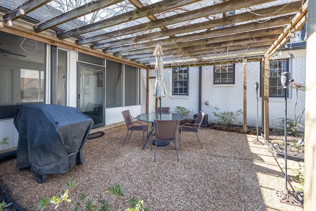 view of patio with area for grilling and a pergola