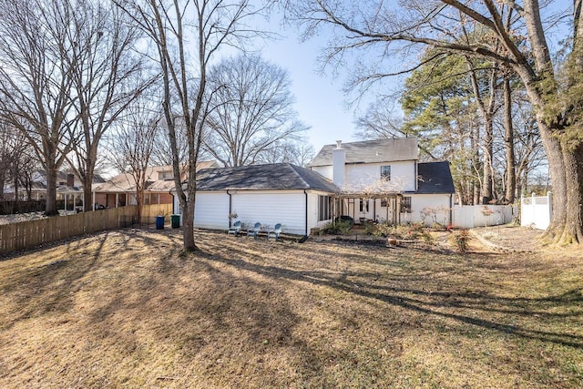 back of house with a yard