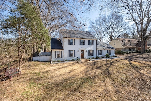 colonial-style house with a front lawn