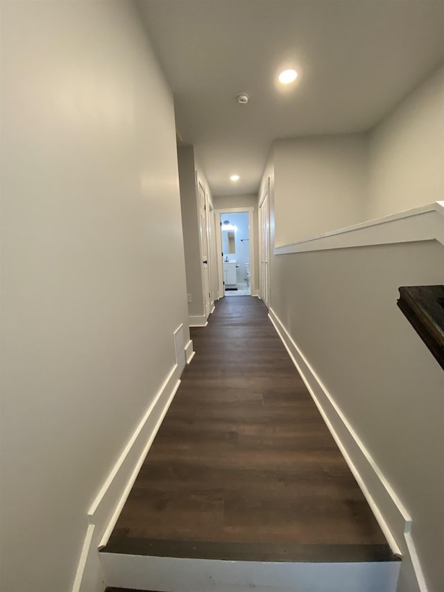 hallway with dark wood-type flooring