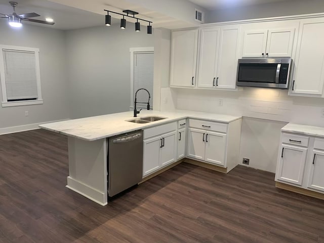 kitchen featuring stainless steel appliances, white cabinetry, and sink