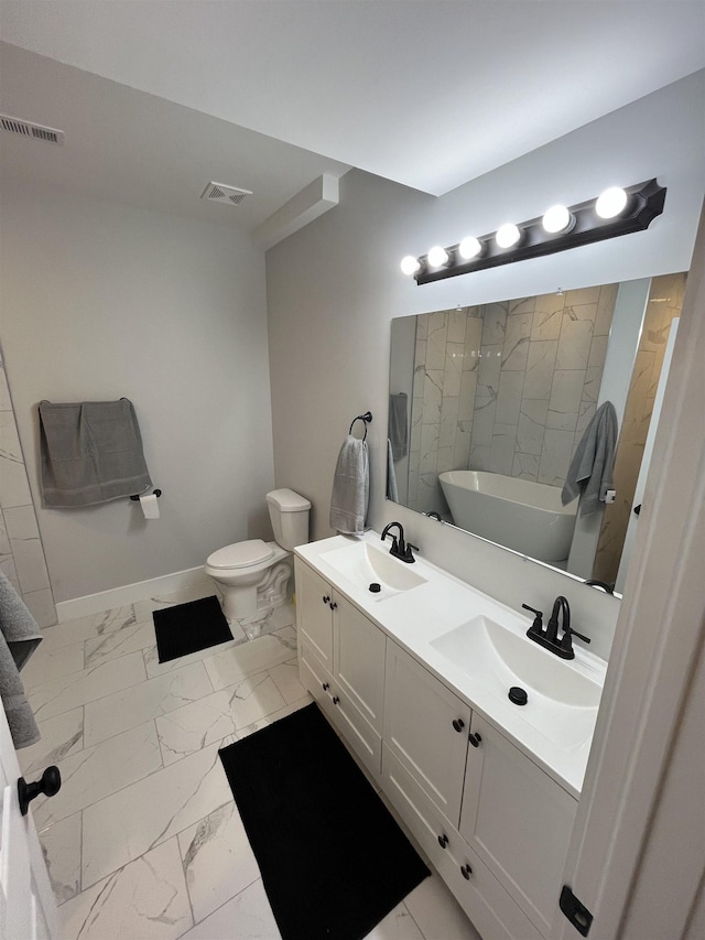 bathroom featuring vanity, toilet, and a bathing tub